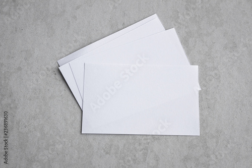 Blank portrait mock-up paper. brochure magazine isolated on gray, changeable background / white paper isolated on gray cement backdrop. © ooddysmile