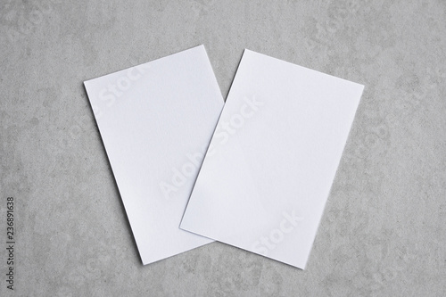 Blank portrait mock-up paper. brochure magazine isolated on gray, changeable background / white paper isolated on gray cement backdrop. © ooddysmile