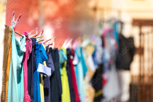 Multicolored clothes hanged and drying in a line outdoors a house, Pylos, Greece.