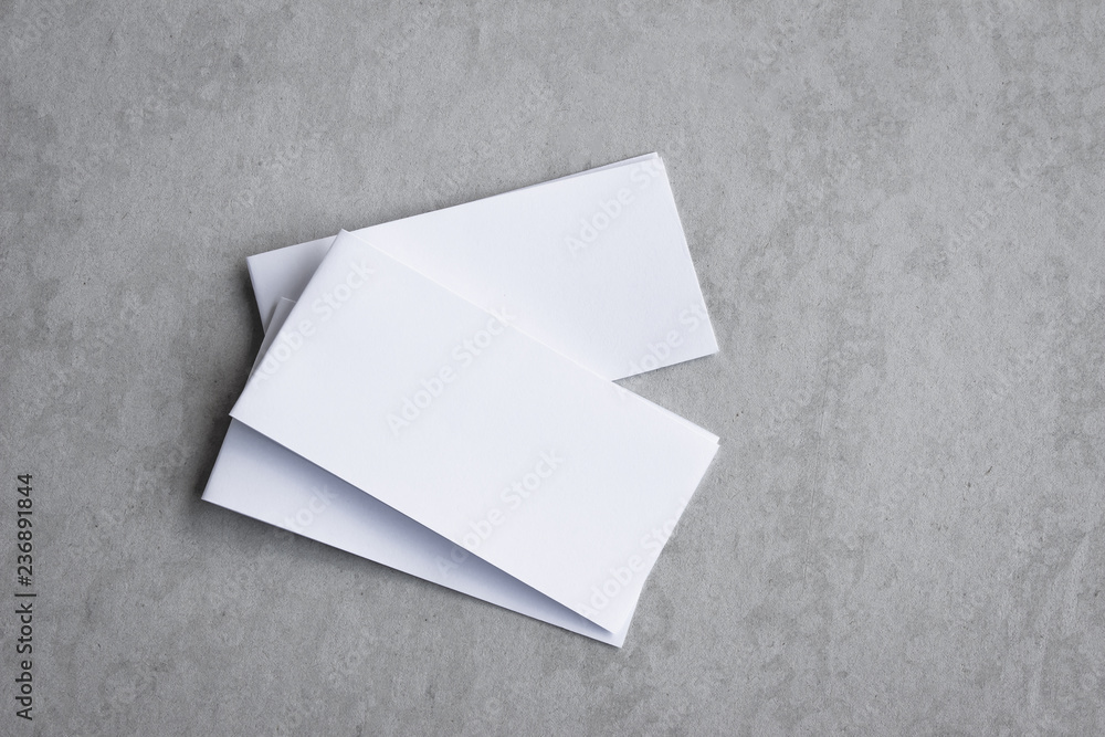 Blank portrait mock-up paper. brochure magazine isolated on gray, changeable background / white paper isolated on gray cement backdrop. Blank portrait mock-up paper. brochure magazine isolated on gray, changeable background / white paper isolated on gray cement backdrop.