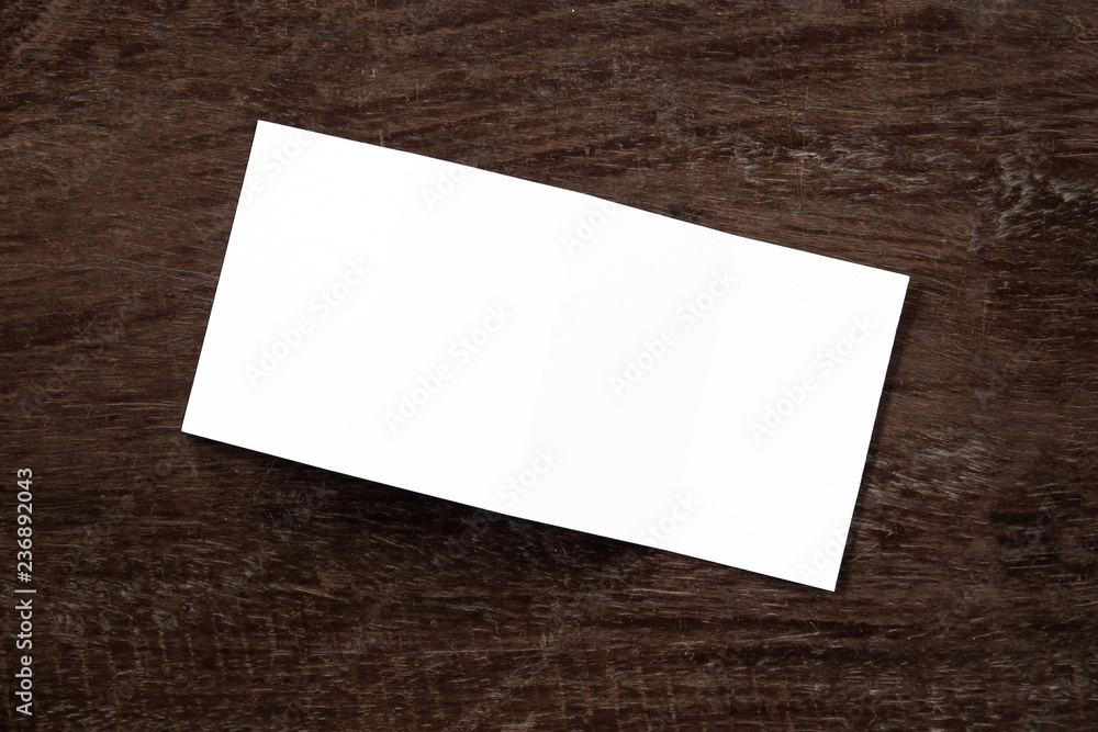 Blank portrait mock-up paper. brochure magazine isolated on brown wooden table, changeable background / white paper isolated on wood Blank portrait mock-up paper. brochure magazine isolated on brown wooden table, changeable background / white paper isolated on wood