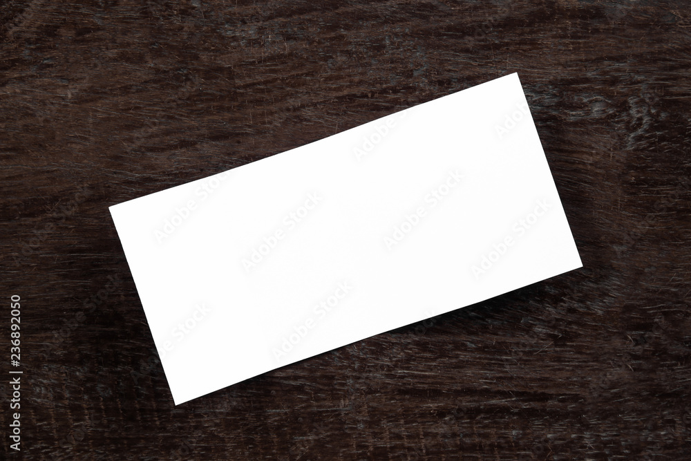 Blank portrait mock-up paper. brochure magazine isolated on brown wooden table, changeable background / white paper isolated on wood Blank portrait mock-up paper. brochure magazine isolated on brown wooden table, changeable background / white paper isolated on wood