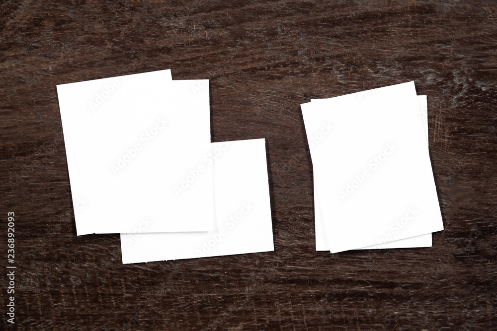 Blank portrait mock-up paper. brochure magazine isolated on brown wooden table, changeable background / white paper isolated on wood Blank portrait mock-up paper. brochure magazine isolated on brown wooden table, changeable background / white paper isolated on wood