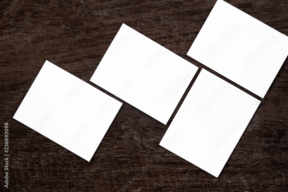 Blank portrait mock-up paper. brochure magazine isolated on brown wooden table, changeable background / white paper isolated on wood Blank portrait mock-up paper. brochure magazine isolated on brown wooden table, changeable background / white paper isolated on wood
