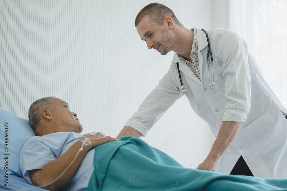 Doctor touching hands to encouragement mental of elderly patient after surgery at bed in hospital. Doctor touching hands to encouragement mental of elderly patient after surgery at bed in hospital.