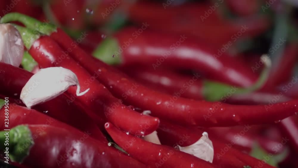 Falling of garlic into the red hot pepper. Slow motion 480 fps
