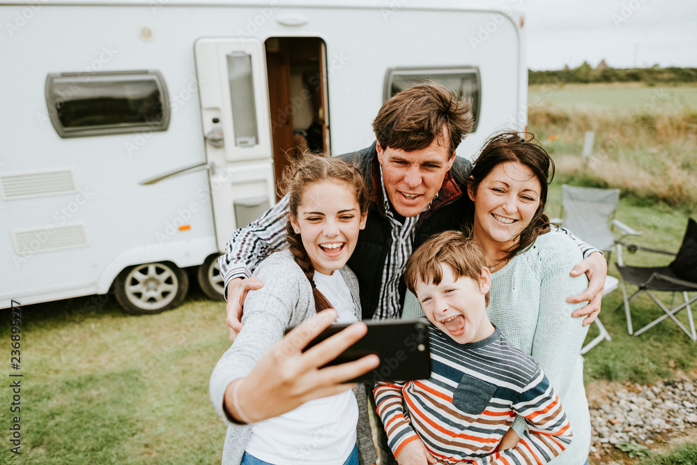 Happy family taking a selfie - obrazy, fototapety, plakaty 