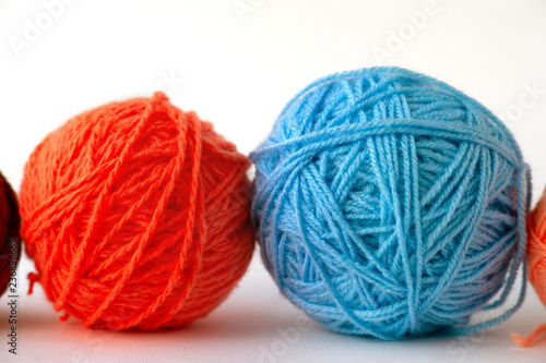Balls of yarn on a white background. Macro. Colorful balls of yarn for knitting on a white background. Knitting is a type of needlework and hobby.