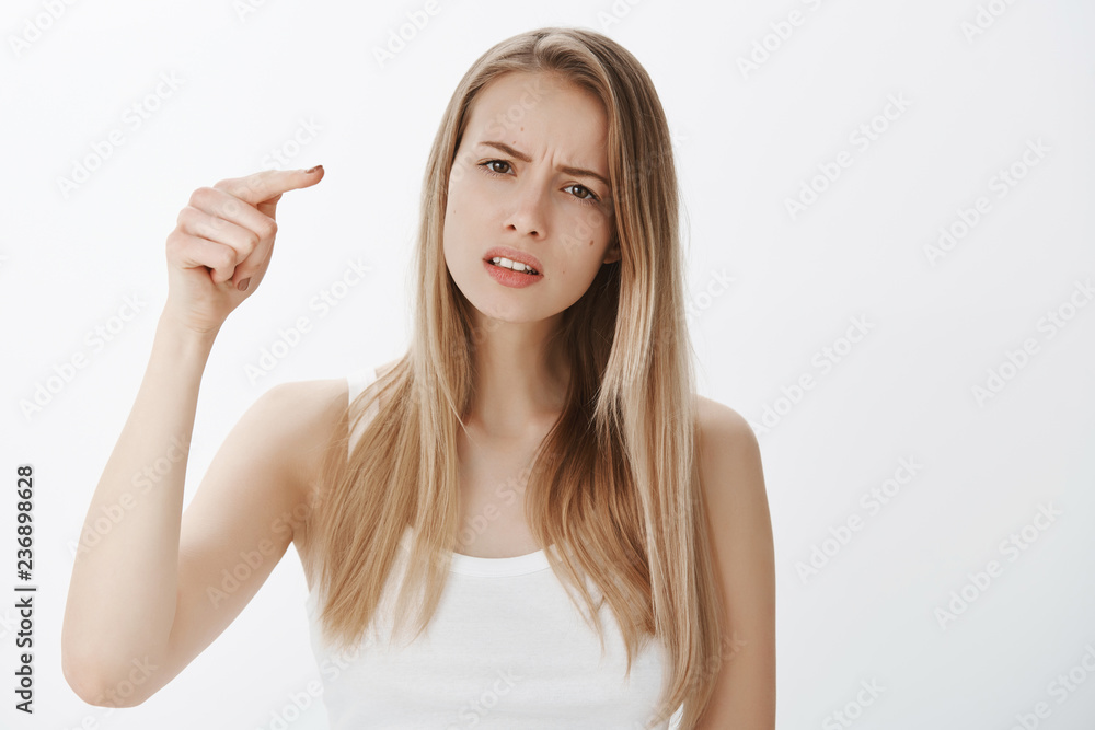 Girl blaming friend for hurting her feelings, being offended and hurt, pointing at camera as accusing someone frowning and squinting, sad as mate let her down standing gloomy over gray background Girl blaming friend for hurting her feelings, being offended and hurt, pointing at camera as accusing someone frowning and squinting, sad as mate let her down standing gloomy over gray background