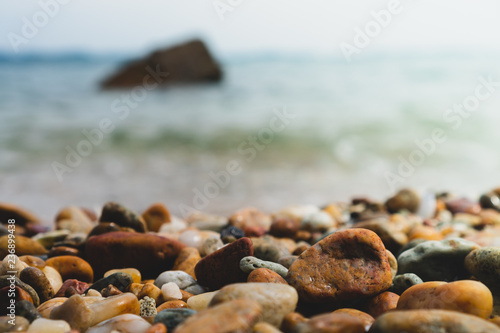 Selective focus on rocks texture with blur beach for display product.
