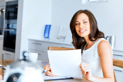Woman with papers in their living room
