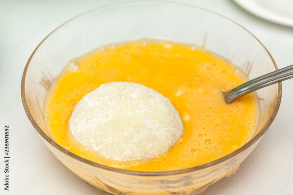 Preparation steps of traditional Colombian dish called stuffed potatoes: Dunking stuffed potatoes in egg and flour mixture Preparation steps of traditional Colombian dish called stuffed potatoes: Dunking stuffed potatoes in egg and flour mixture
