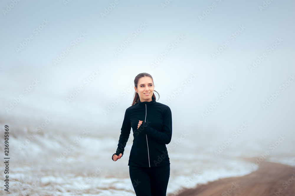 Female Jogger Running Outdoors in Winter Cold Female Jogger Running Outdoors in Winter Cold