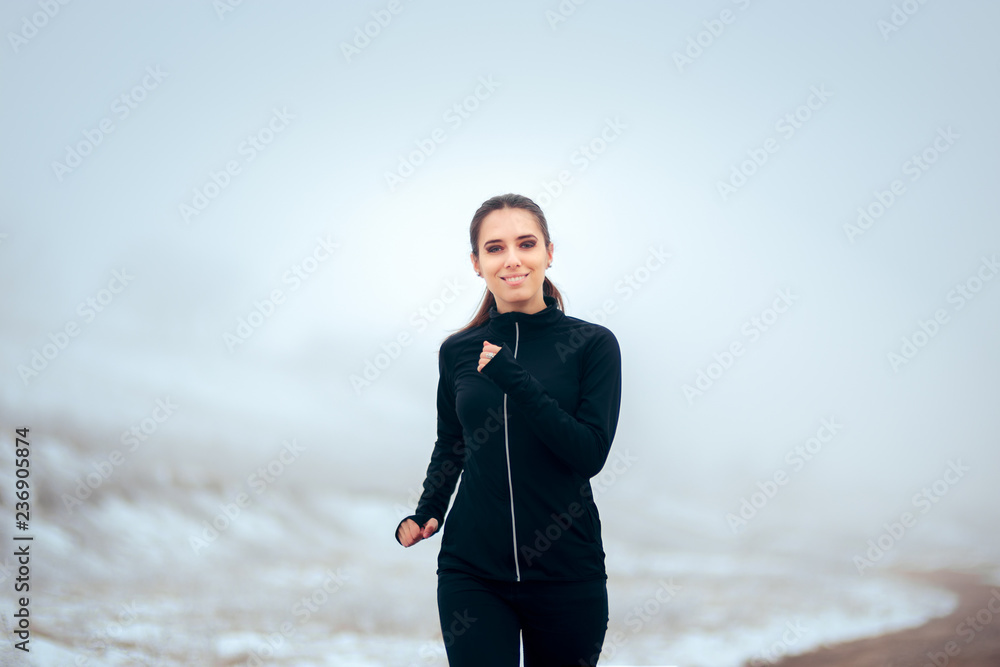 Female Jogger Running Outdoors in Winter Cold Female Jogger Running Outdoors in Winter Cold