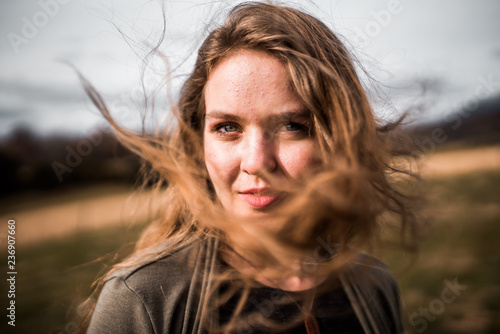 Wind blows woman's long blonde hair