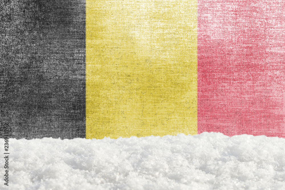 Fototapeta premium Winter grunge background with snowdrift and Belgian flag in the backdrop