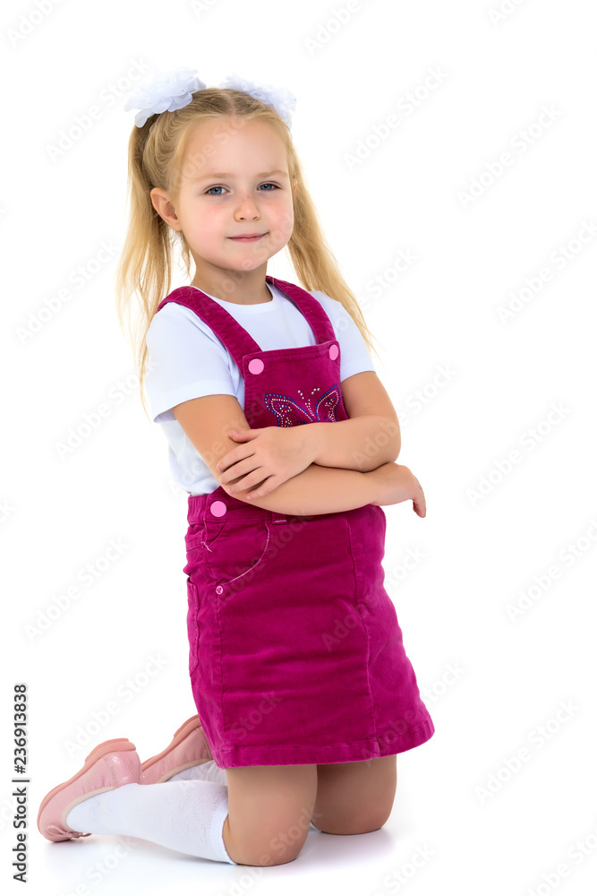 The little girl is on her knees. The little girl is on her knees.