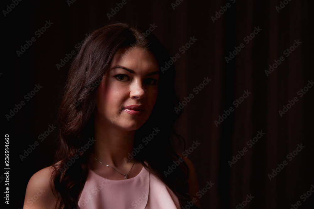 Mysterious portrait of a girl in a light dress in black room. Dark key Mysterious portrait of a girl in a light dress in black room. Dark key