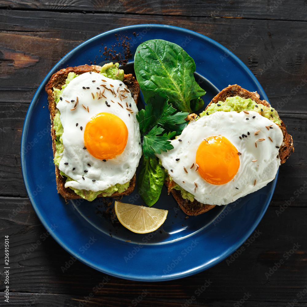 Top view healthy avocado toasts fried egg cheerful faces Healthy breakfast table Top view healthy avocado toasts fried egg cheerful faces Healthy breakfast table