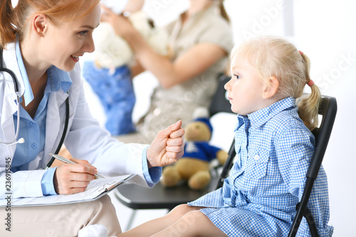 Doctor and a little blonde girl. Usual health exam. Medicine and healthcare concept