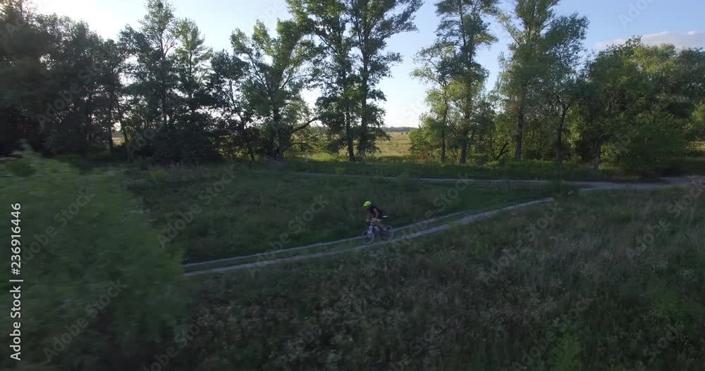 Cycling Aerial. Cyclist From Drone. MTB Cyclist Aerial View.Man Ride Bike On Rural Road.Healthy man cycling MTB bicycle outdoors fitness. Cycling Aerial. Cyclist From Drone. MTB Cyclist Aerial View.Man Ride Bike On Rural Road.Healthy man cycling MTB bicycle outdoors fitness.
