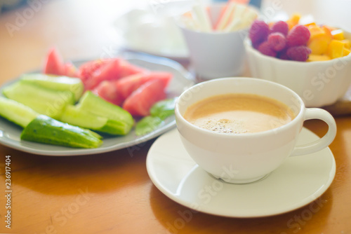Breakfast with coffee, egg, vegetables and fruits