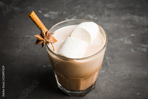 Sweet hot chocolate in glass. Christmas drink with spices and marshmallow. Selective focus. Shallow depth of field. 