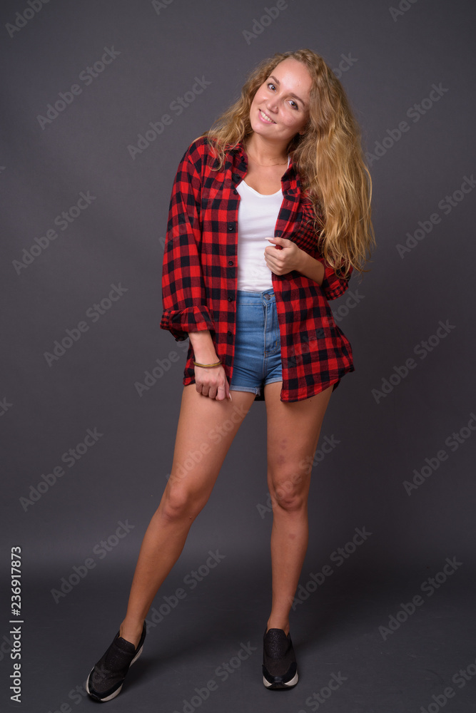 Full length portrait of young beautiful woman with long wavy blond hair Full length portrait of young beautiful woman with long wavy blond hair