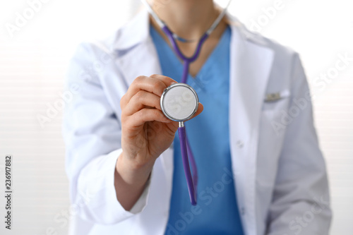 Doctor holds stethoscope head, closeup. Physician ready to examine and help patient. Medical help and insurance in health care, best treatment and medicine concept
