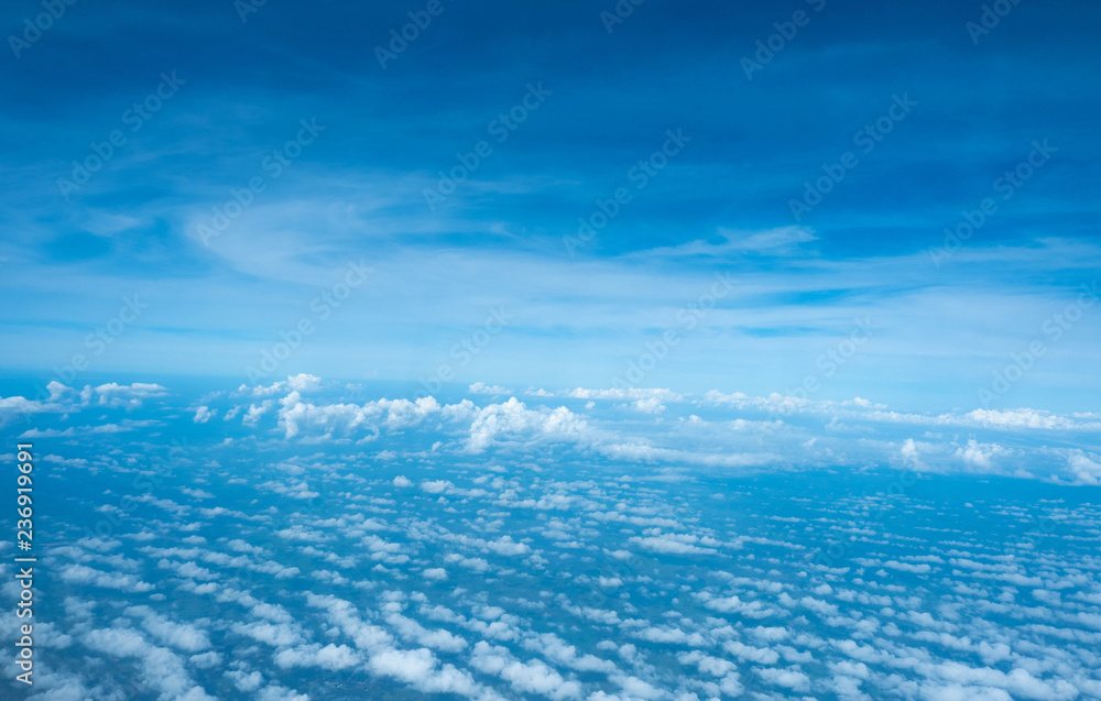 Clouds seen from an airplane, blue sunshine, soil background nature landscape