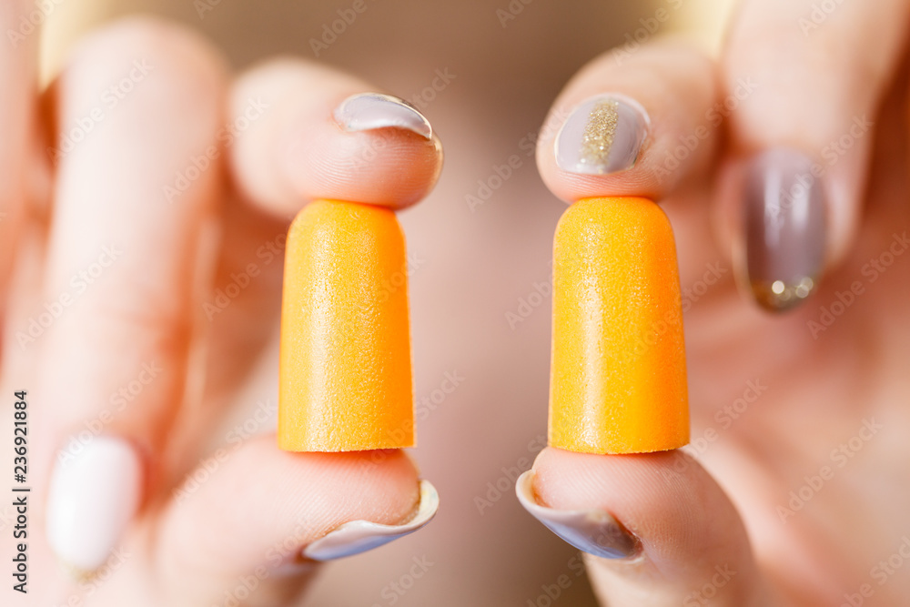 Woman holding protective earplugs Woman holding protective earplugs