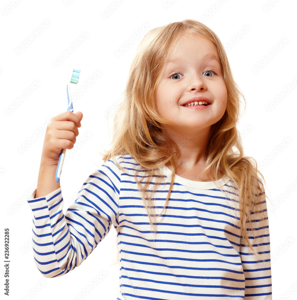 A little girl in striped pajamas is brushing her teeth with a toothbrush. The concept of daily hygiene. Isolated on white background A little girl in striped pajamas is brushing her teeth with a toothbrush. The concept of daily hygiene. Isolated on white background