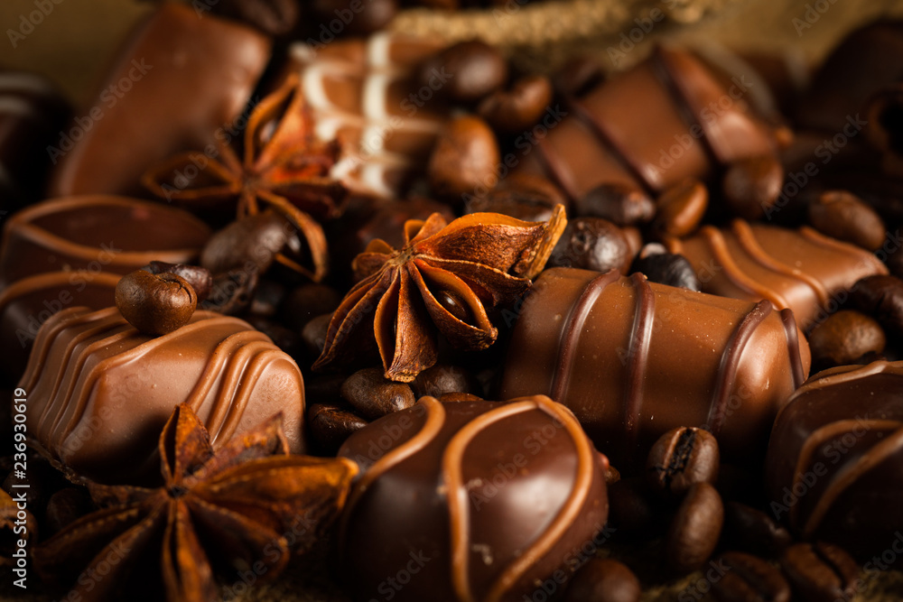 Assortment of white, dark, and milk chocolate. Chocolate with cream, nuts, almonds, hazelnuts and cinnamon with coffee beans. Sweet food and no diet concept. Assortment of white, dark, and milk chocolate. Chocolate with cream, nuts, almonds, hazelnuts and cinnamon with coffee beans. Sweet food and no diet concept.