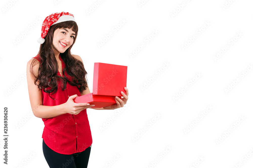 Woman in santa hat opening Christmas gift box isolated on white with copyspace. Happy girl unpacking her present Woman in santa hat opening Christmas gift box isolated on white with copyspace. Happy girl unpacking her present
