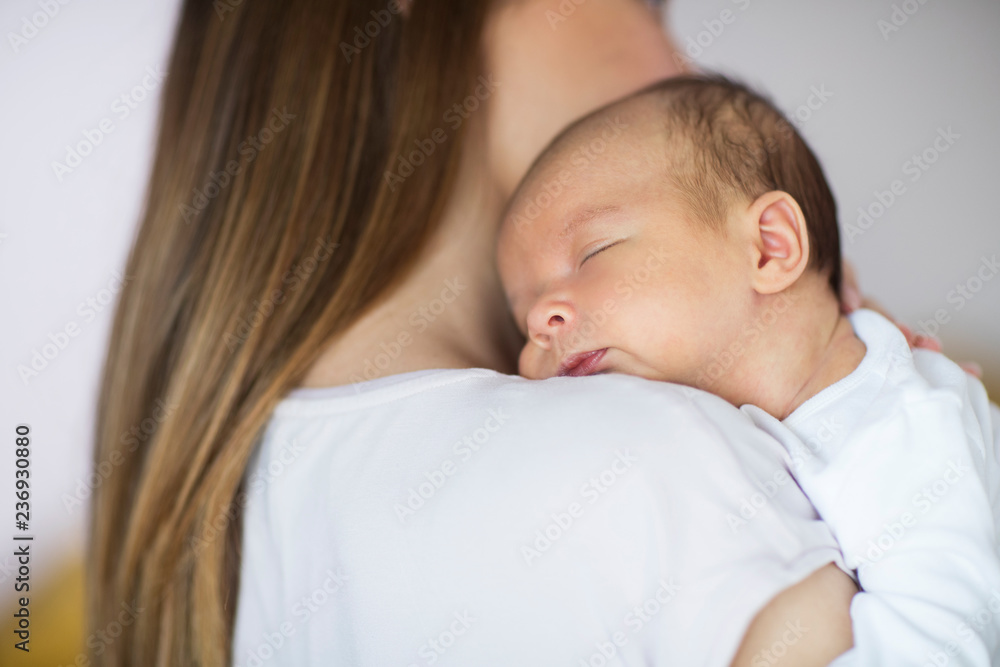 Loving Mother Cuddling Sleeping Newborn Baby Son Over Shoulder Loving Mother Cuddling Sleeping Newborn Baby Son Over Shoulder