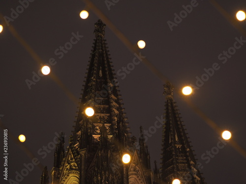 Christmas market in Cologne, Germany with the Cologne Cathedral in the background.