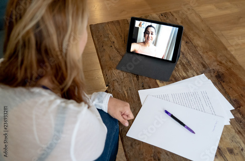 Quadro em tela Beautiful freelance woman consultant having a video conference call with online