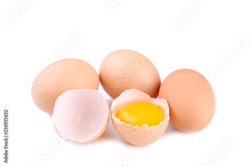 Chicken eggs and half with yolk on a white background.