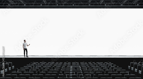 Presentation hall with person on scene auditorium blank screen mockup photo