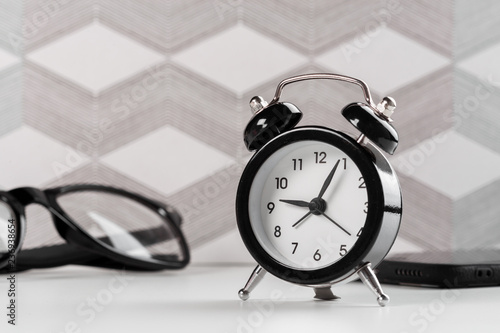 Vintage background with retro alarm clock on table