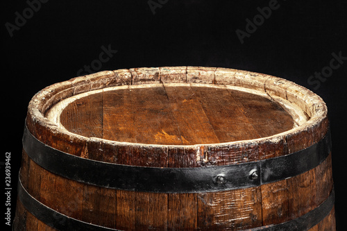 Old wooden barrel on a dark background © NewFabrika