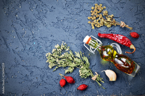 Fototapeta Naklejka Na Ścianę i Meble -  Dark culinary background with olive oil, pepper, garlic, spices