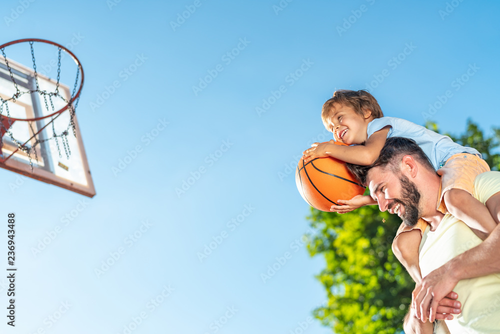 Fototapeta premium Father and son playing basketball