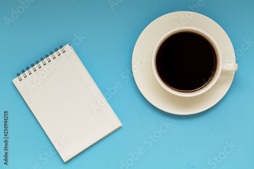 cup of coffee and notebook on table