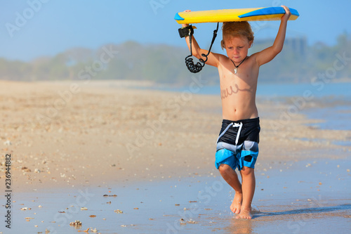Photography Baby boy - little surfer run with bodyboard to sea for riding on waves