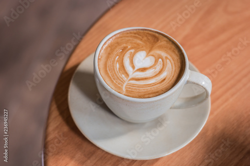 Coffee latte hearts shaped stacked on wooden floor