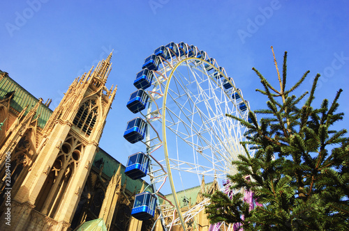 Christmas Ferris wheel in front of the cathedral of Metz and Christmas tree. Metz, France.
