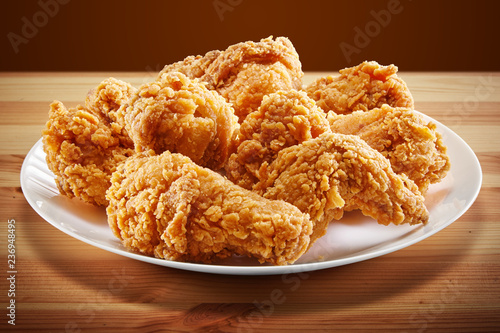 crispy coated batter southern style fried chicken in a wooden table