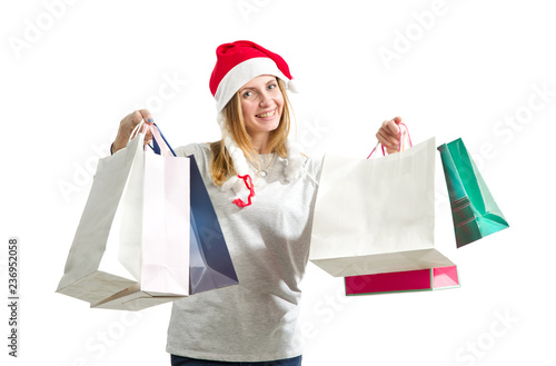 Young woman is holding a package with New Year gifts isolated on a white background. Christmas shopping.