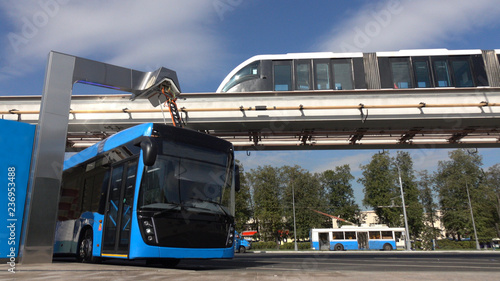 Obraz na płótnie Blue electric bus at the charging station.Modern trains on the monorail. w salonie